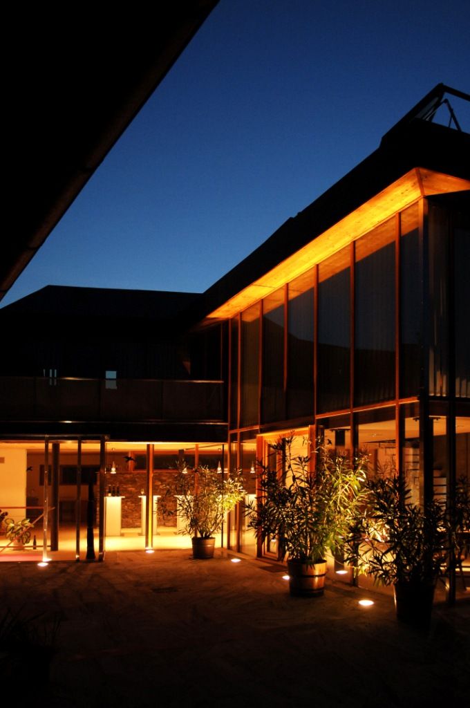 Illuminated inner courtyard of a modern building at night.