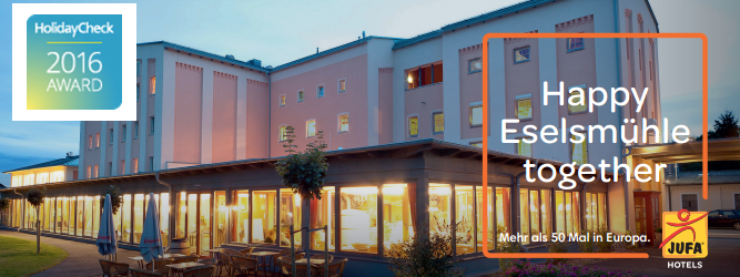 JUFA Hotel Weinviertel, © JUFA Exterior view of the JUFA Hotel at dusk with HolidayCheck Award 2016 logo.