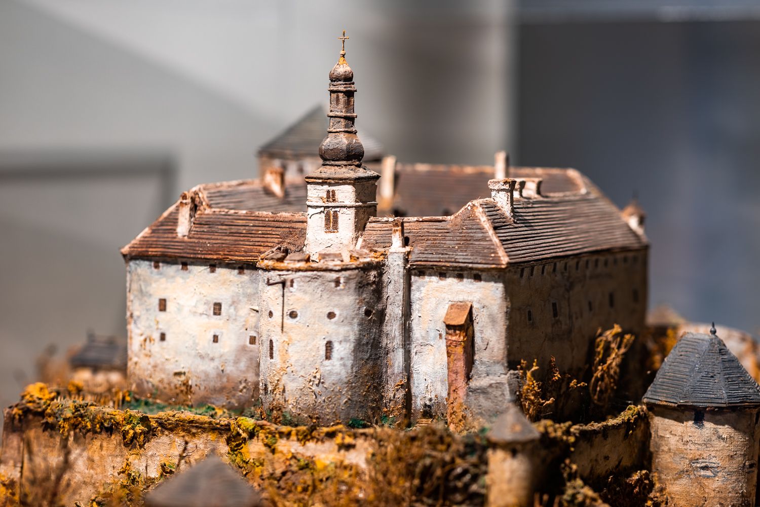 Miniature model of a castle with tower and battlements.