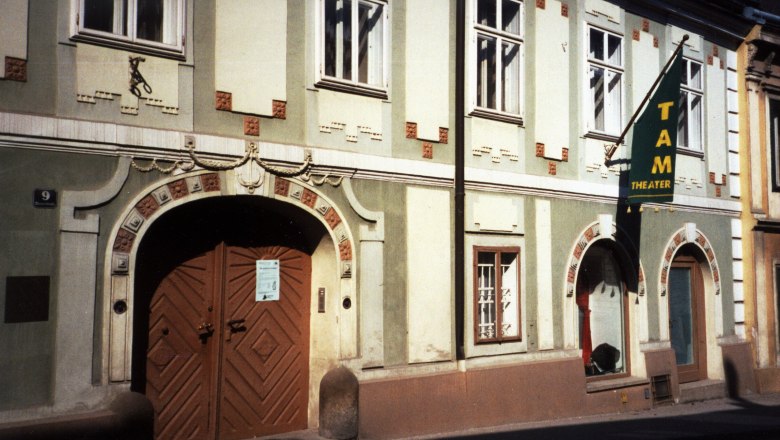 Facade of the TAM - Theater an der Mauer with entrance door and windows.