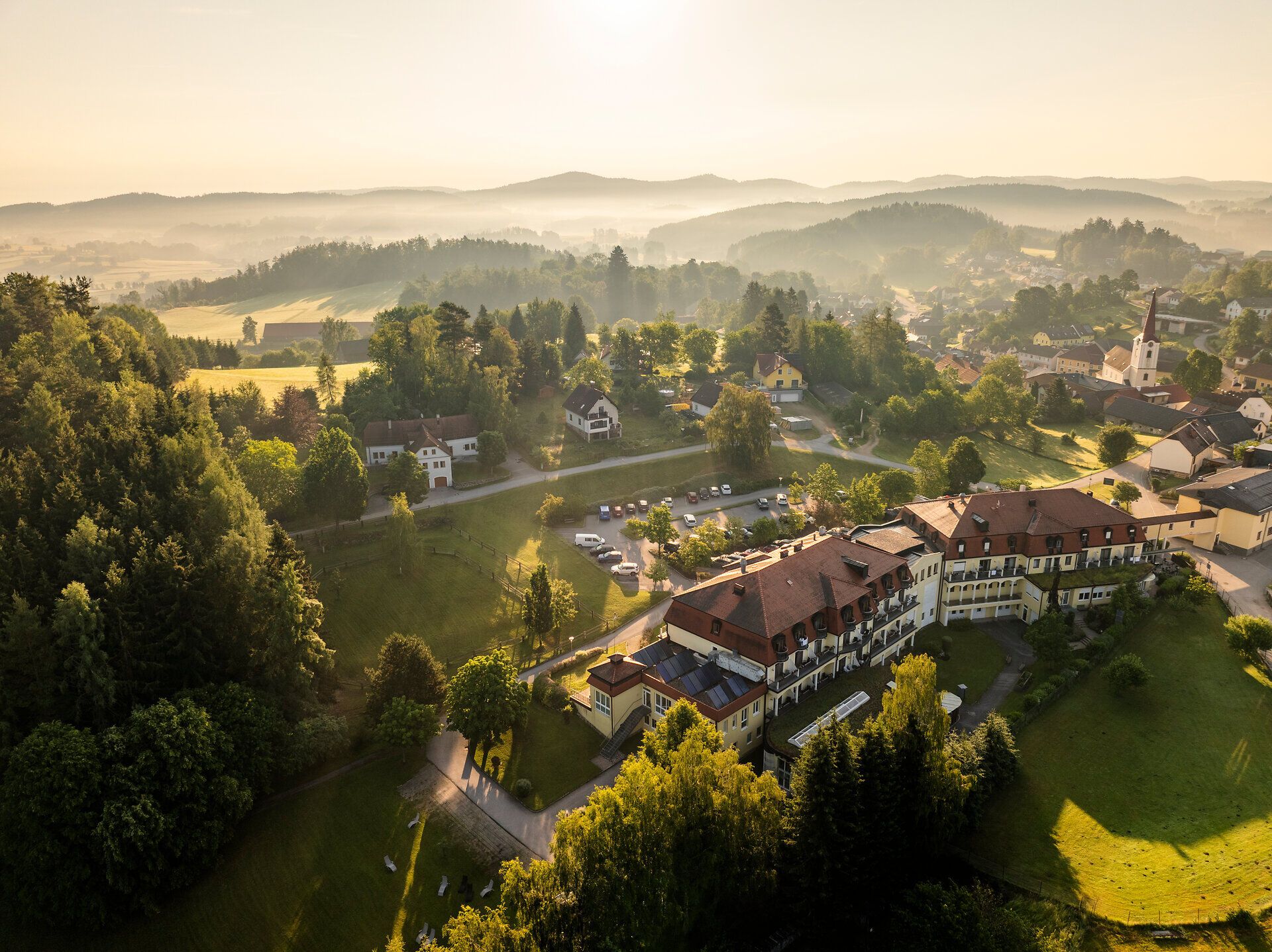 Aerial view of the Bad Großpertholz spa in the Waldviertel region, showing the surrounding town, meadows, and wooded hills.