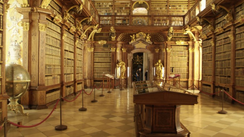 Interior view of the library in Melk Abbey with high bookshelves and decorative elements.