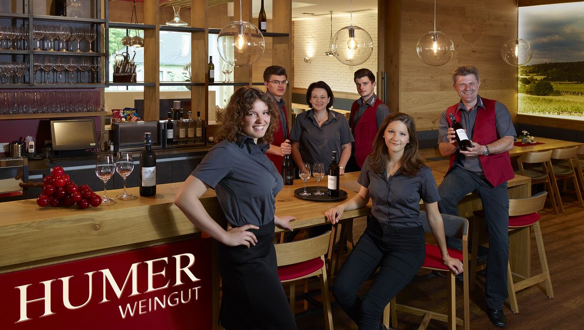 Employees of a winery pose in a modern wine tavern.