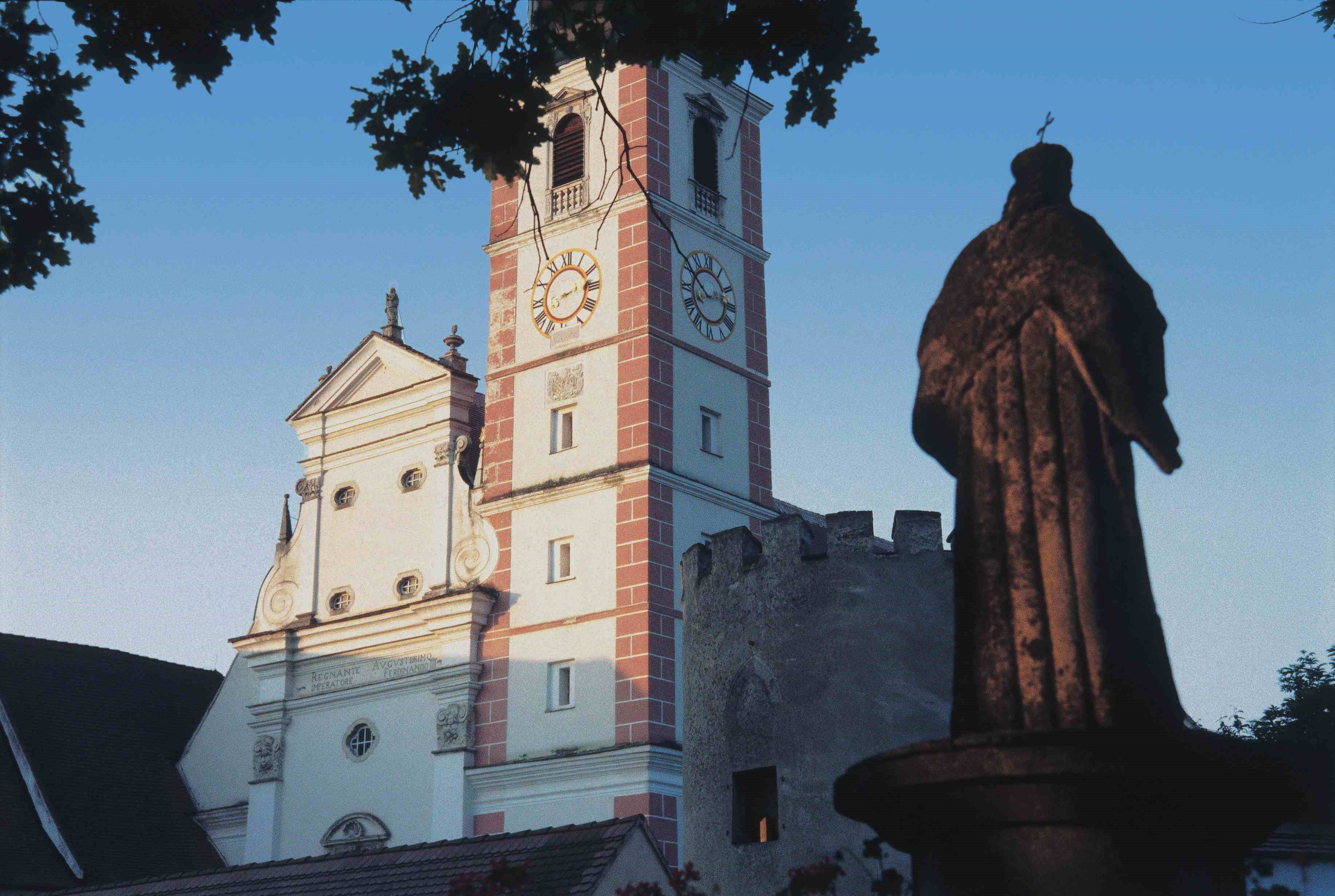Church tower and statue in Geras, Austria.