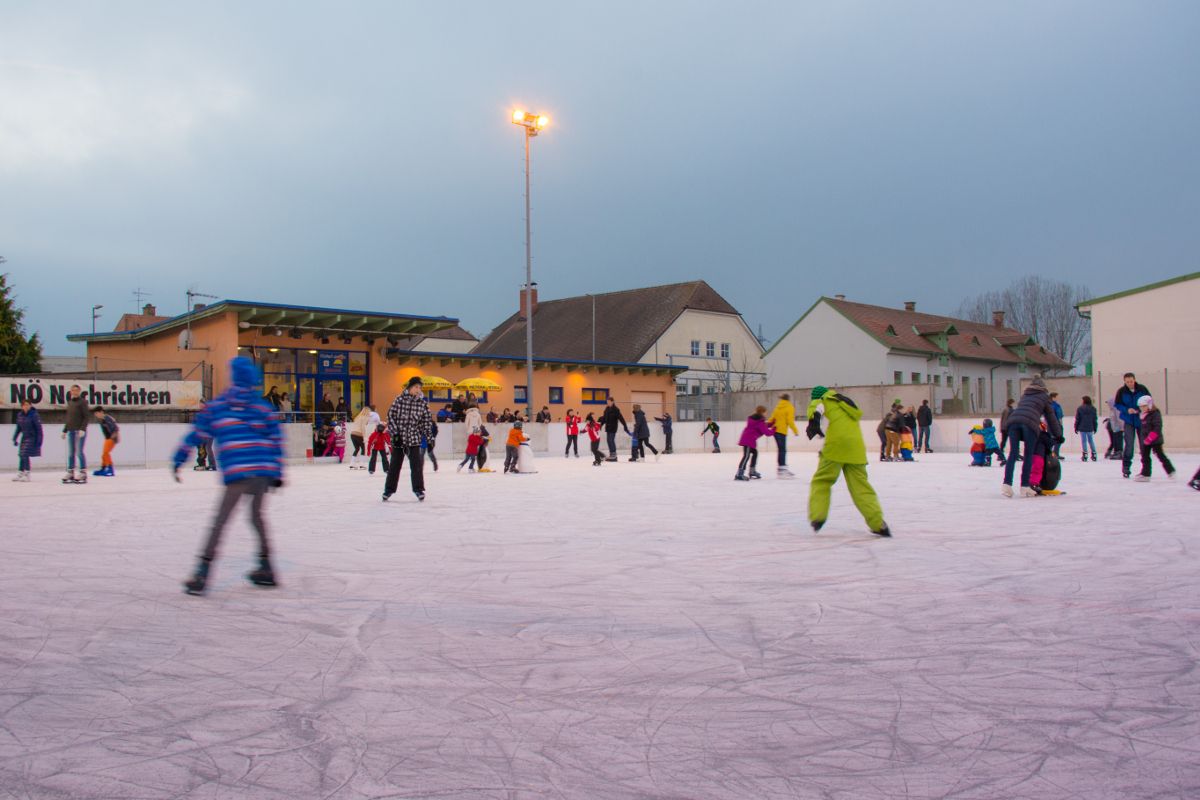 People ice skating on an artificial ice rink in Hollabrunn.