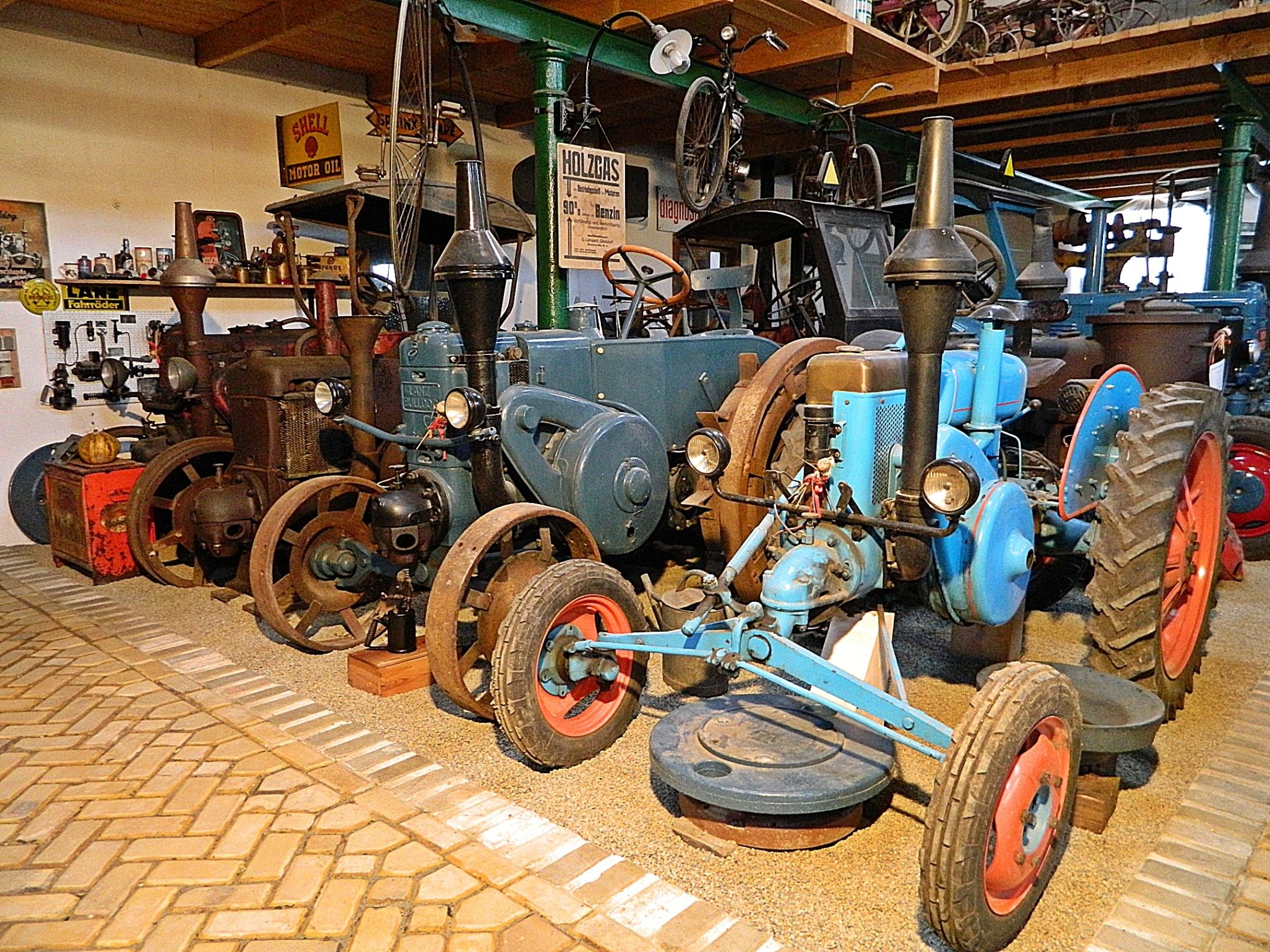 Old tractors on display in a museum.