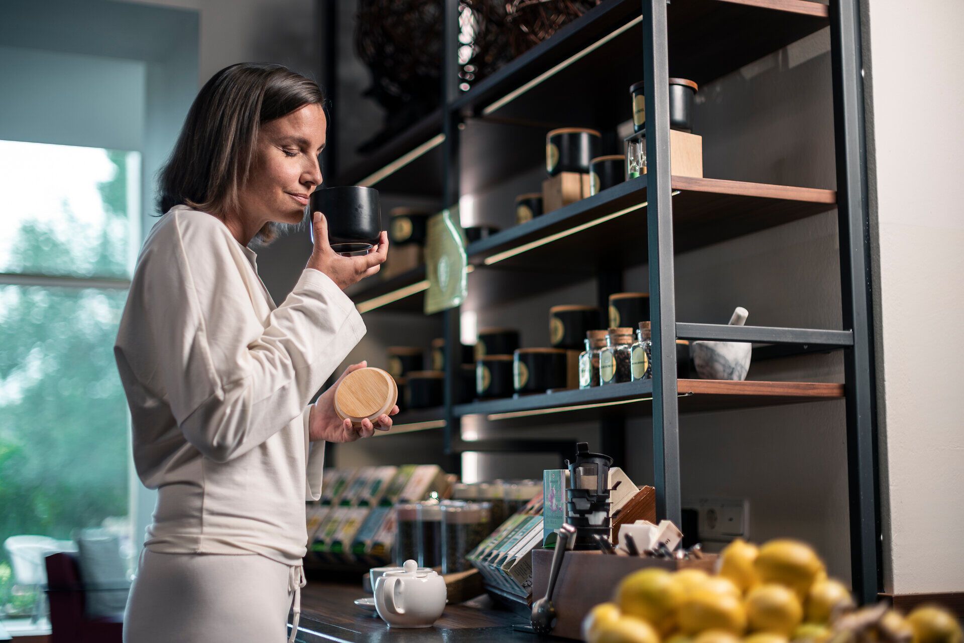 A woman is sniffing a tea can at the Klosterberg Health Hotel in the Waldviertel region.