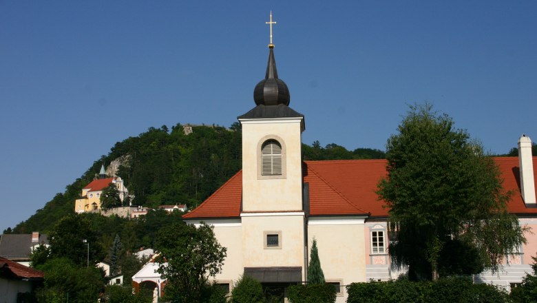 Pitten vicarage with church and hill in the background.