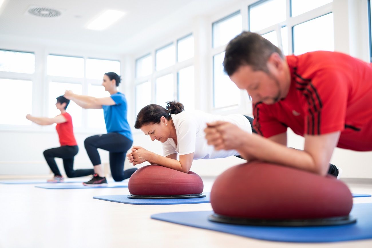 People doing strength and sensorimotor training on mats.