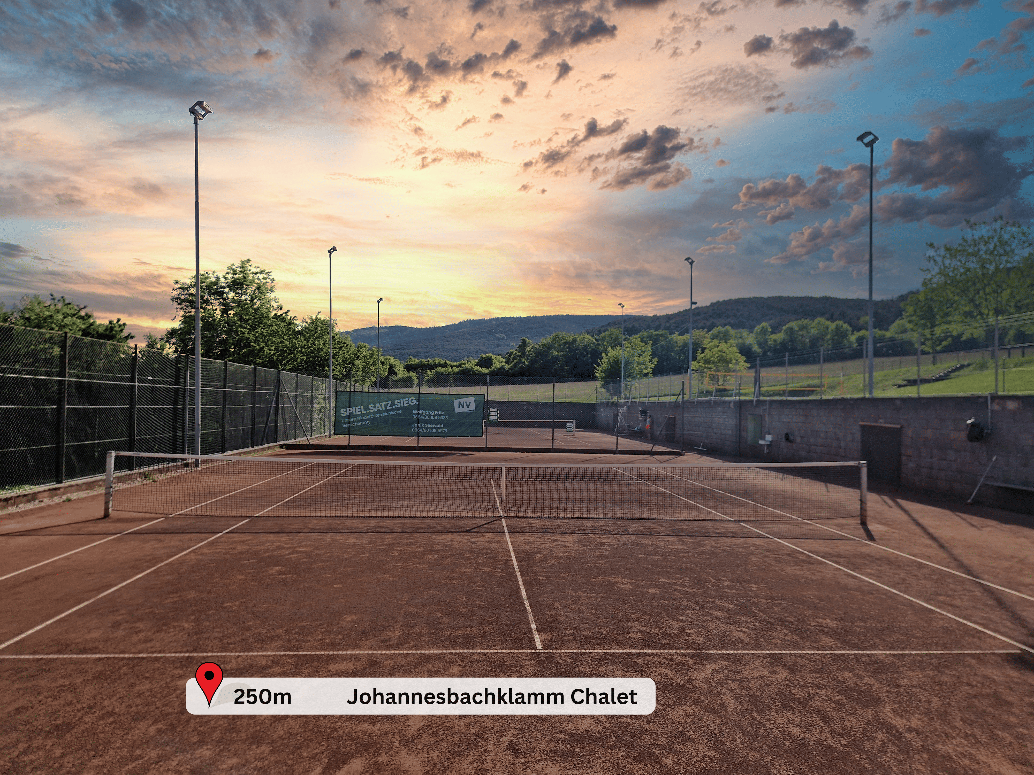 Tennis court at sunset with reference to Johannesbachklamm Chalet 250 meters away.