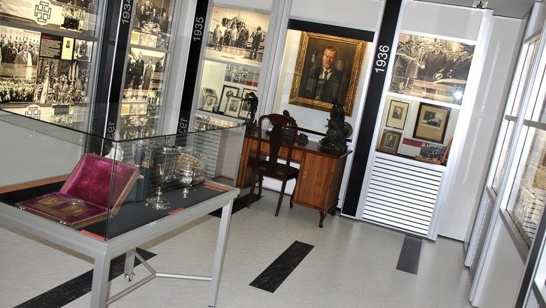 Interior view of a museum with historical exhibits and photos.