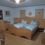 Cozy double room with wooden furniture and two single beds.