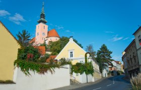 Street in Poysdorf with church in the background and blue sky.