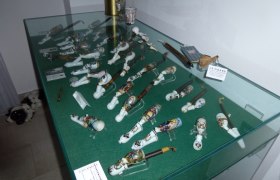Display case with decorative pipes in a museum.