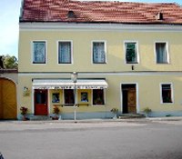Yellow building with snack bar and red roof tiles.