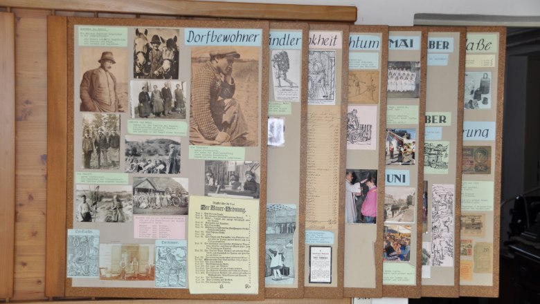 Exhibition panels in the Michelhausen local history museum with historical photos and texts.