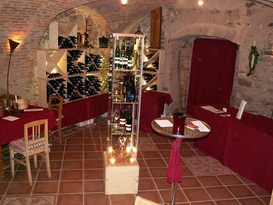 Wine cellar with bottle racks and table.