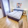Double room with large window and wooden floor