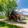Renovated mill with modern loft, surrounded by trees and meadows.