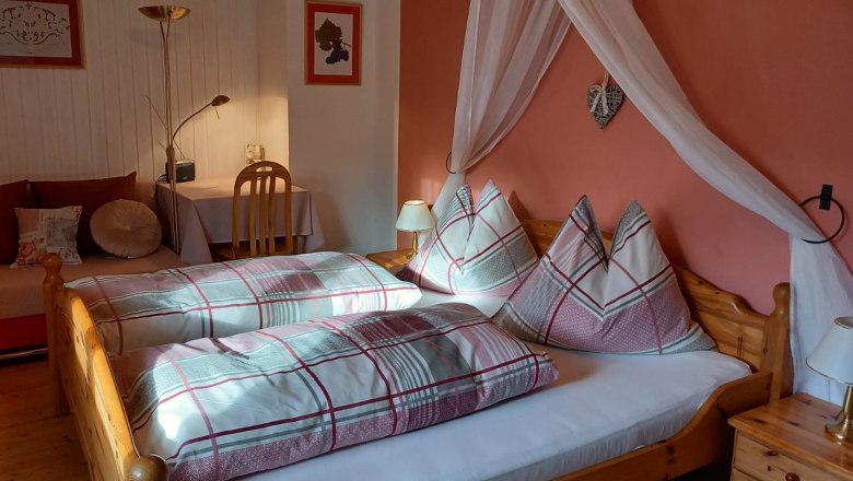 Comfortable guest room with double bed, bedside lamps and desk.