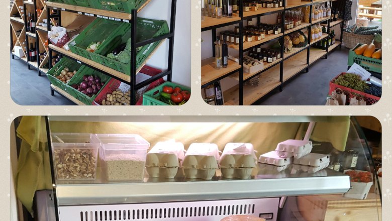 Interior view of a farm store with shelves full of vegetables, jams, eggs and dairy products.