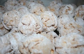 Close-up of pastry balls dusted with powdered sugar.