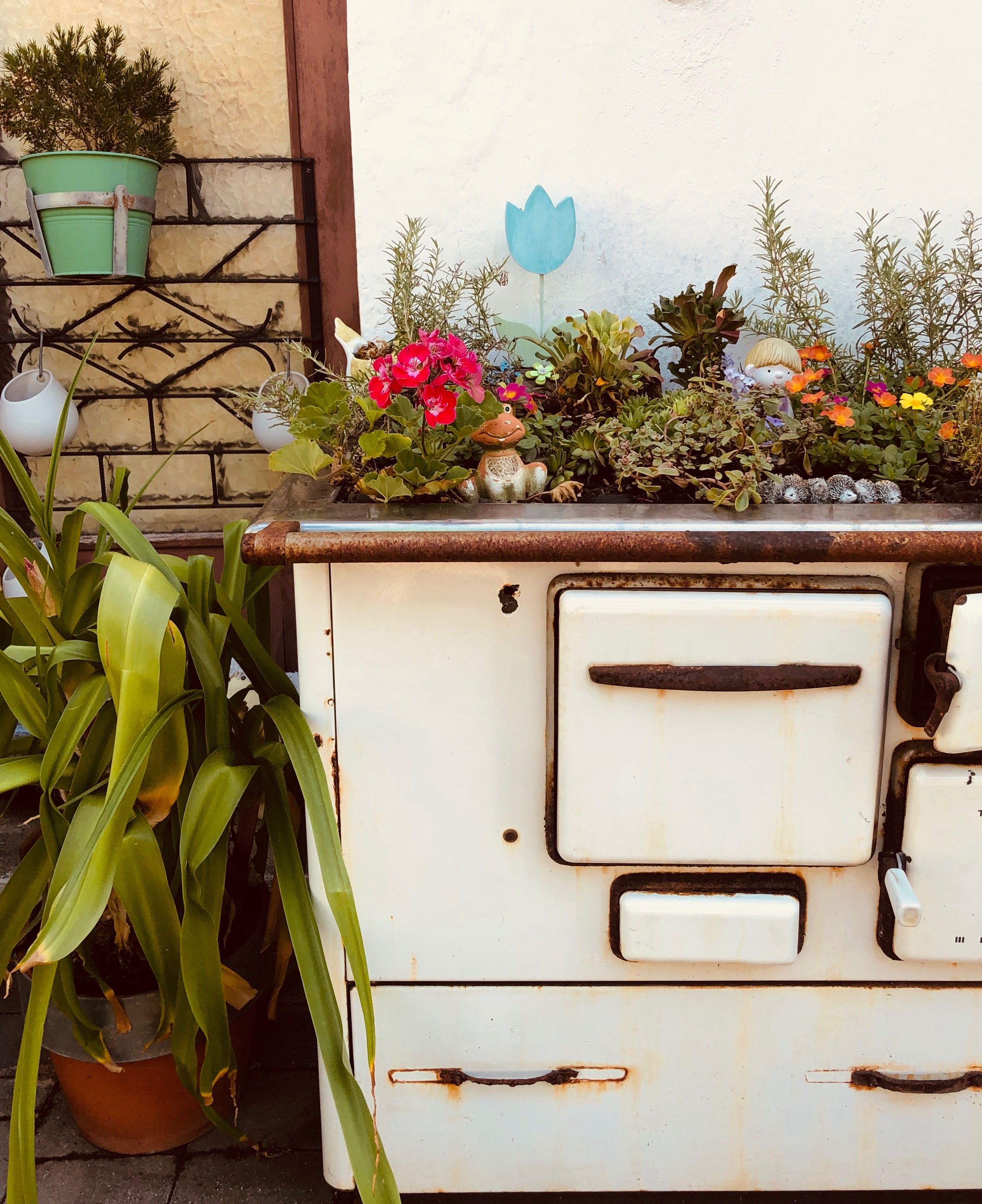 Old stove decorated with flowers and plants.