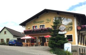 Gasthof Braunegger-Hof with balcony flowers and parasols.