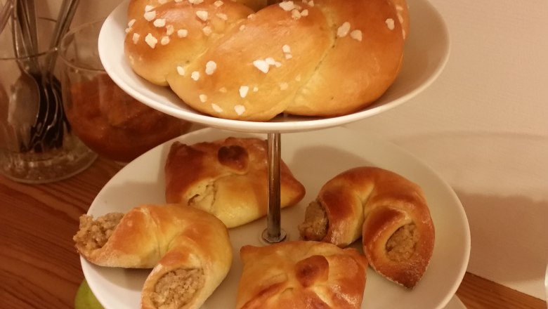 A three-tiered serving stand with pastries and fruit.