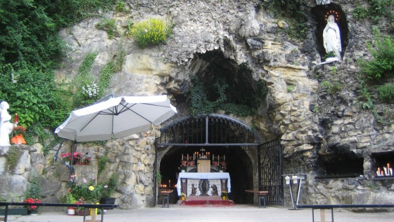 Lourdes grotto in the Vienna Woods with altar and statue of the Virgin Mary.