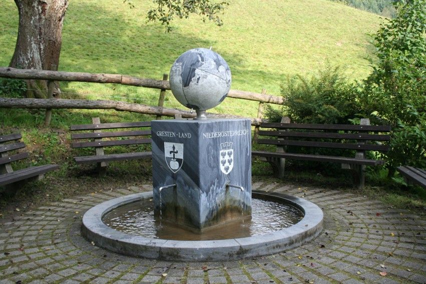 Fountain with globe and coat of arms in Gresten-Land, Lower Austria.