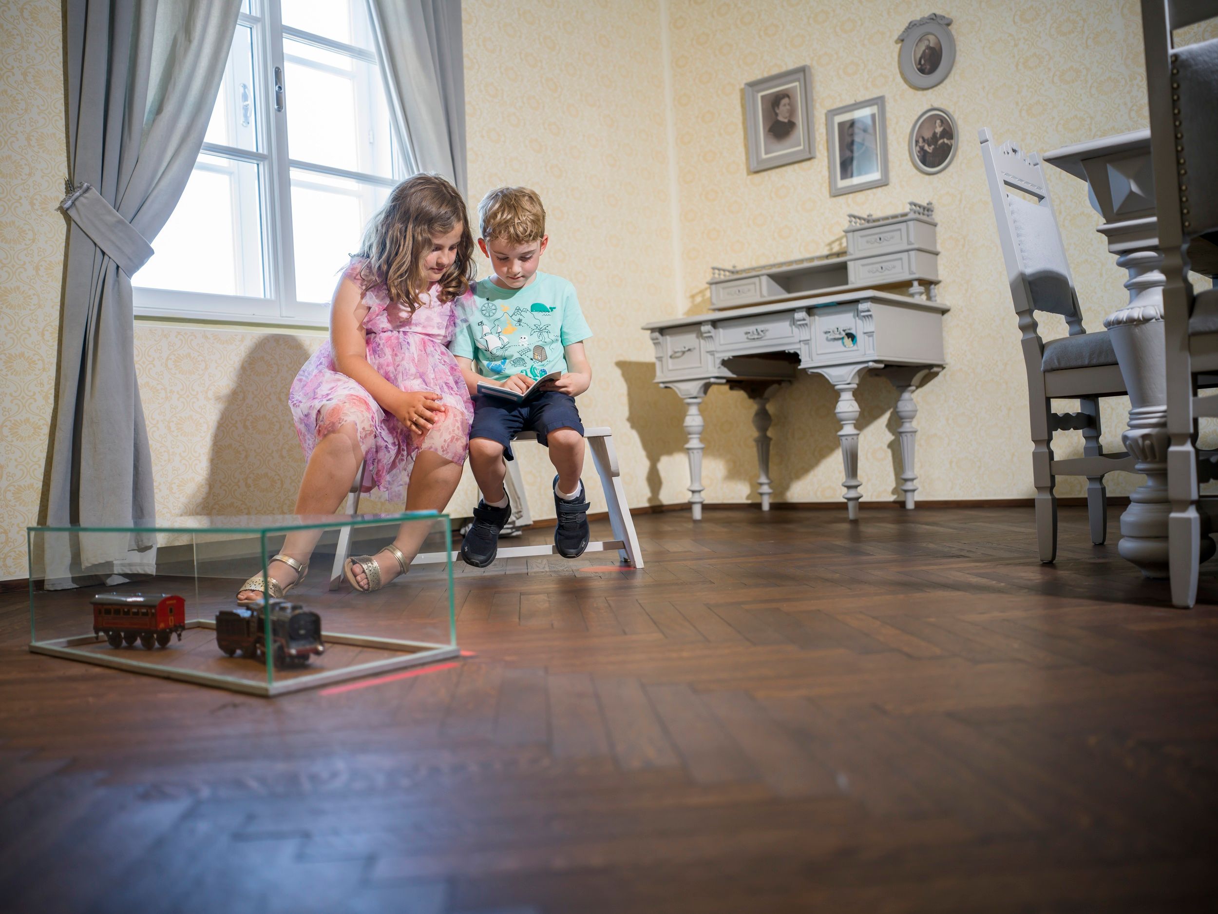 Two children looking at a book at Egon Schiele's birthplace