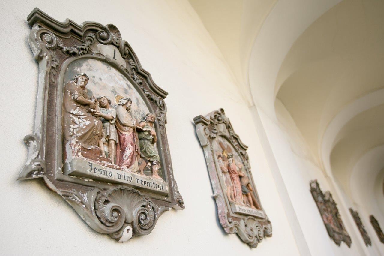 Reliefs on a church wall with religious scenes.