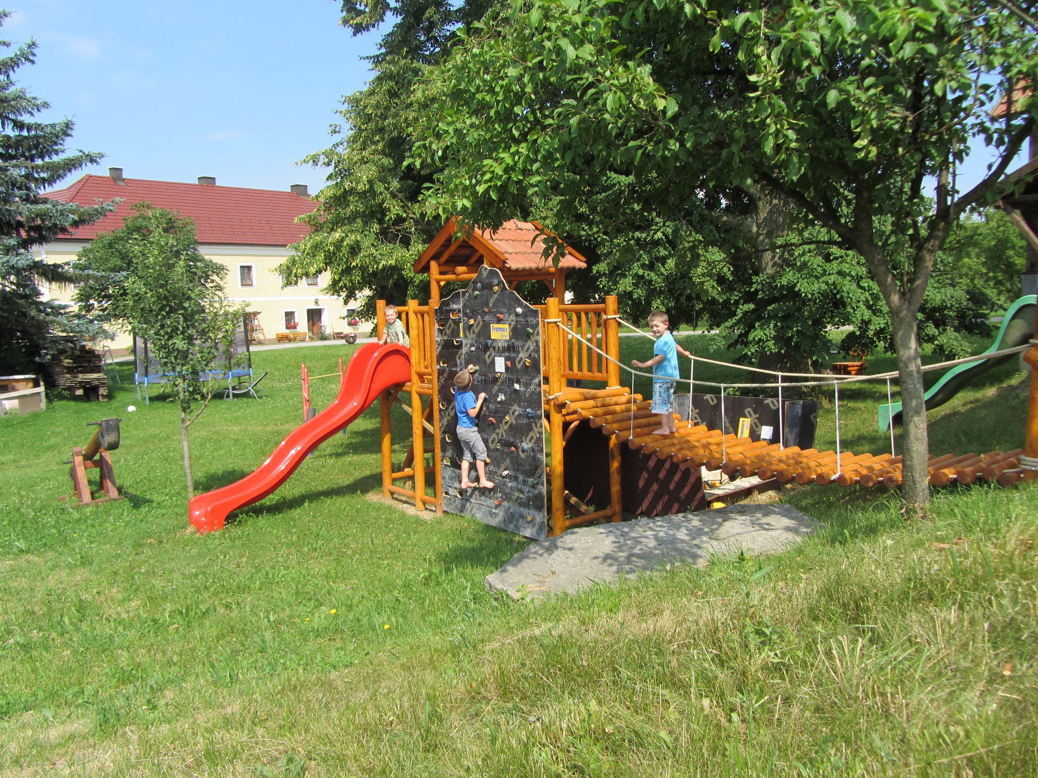 Playground with climbing frame, slide and two children playing.