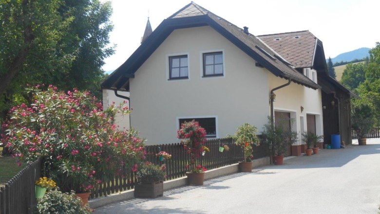 Vacation apartment on a farm with flowers and trees.