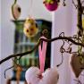 Decorative branch with hanging fabric hearts and colorful eggs.