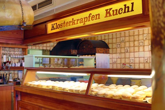 Sales stand with fresh doughnuts in a bakery.