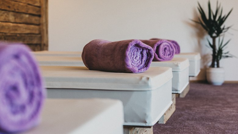 Wellness area with purple towels on loungers.