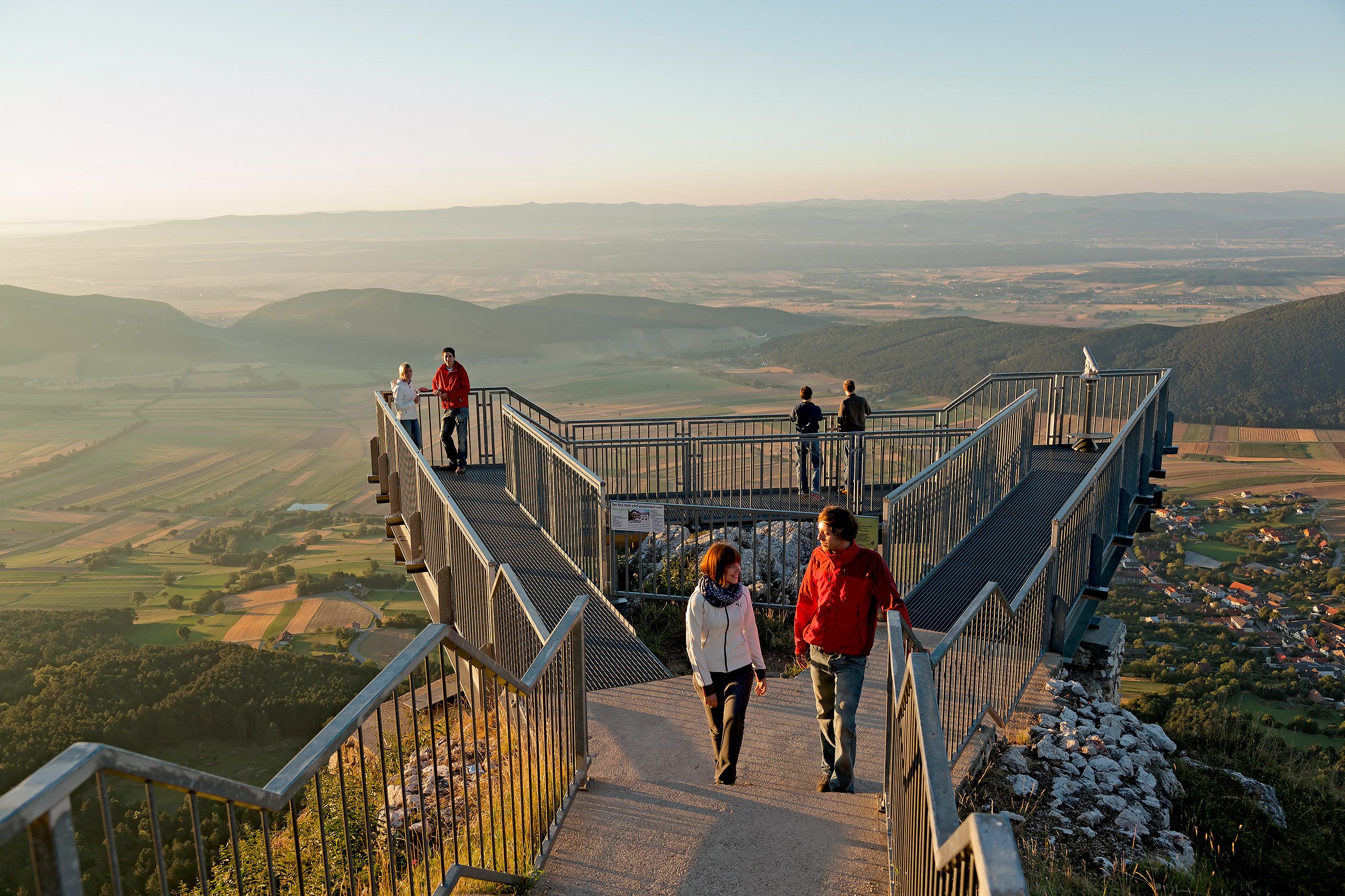 People on the Hohe Wand Skywalk with a view of the landscape.