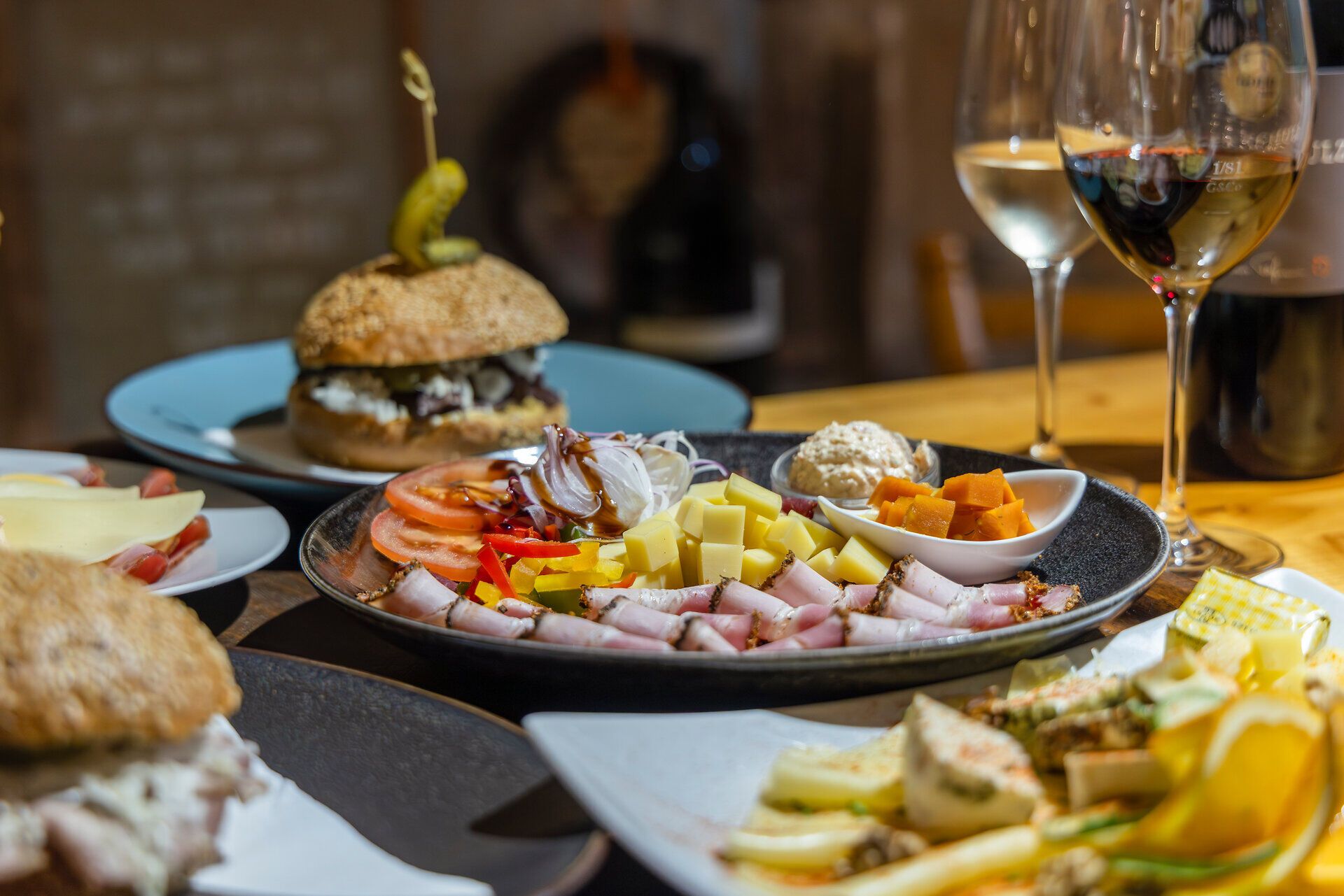 Heurigen dishes and wine glasses on a wooden table. 