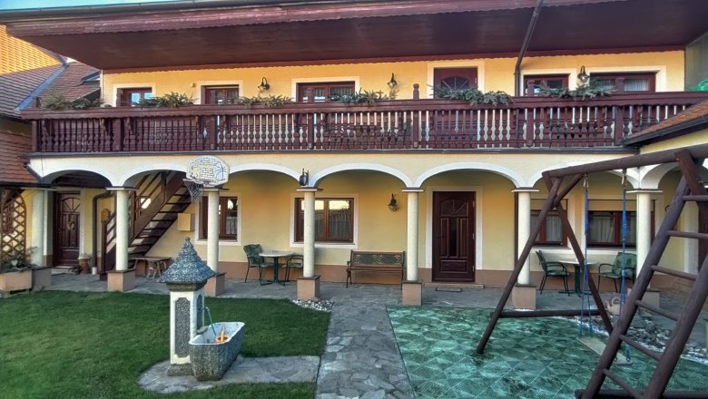 Inner courtyard with arcades, balcony, swing and fountain.