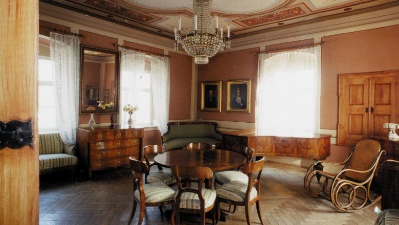 Elegant living room in the Hugo Wolf house with antique furniture and chandelier.