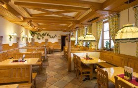 Interior view of a traditional wine tavern with wooden furniture and cozy lighting.