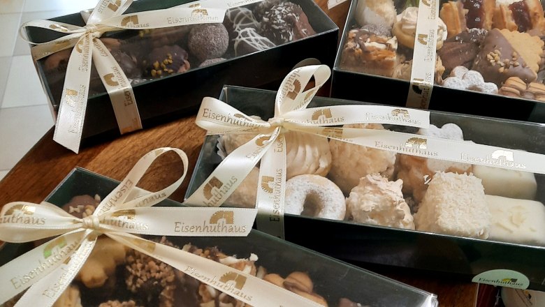 Gift boxes with Christmas cookies on a table.