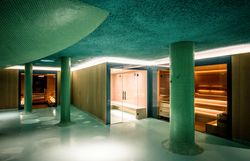 Modern building with pool and terrace in the foreground.