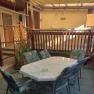 Covered terrace with table and chairs.
