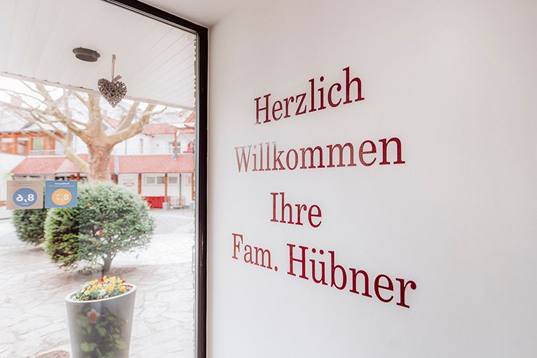 Entrance area with welcome text on the wall and view outside.