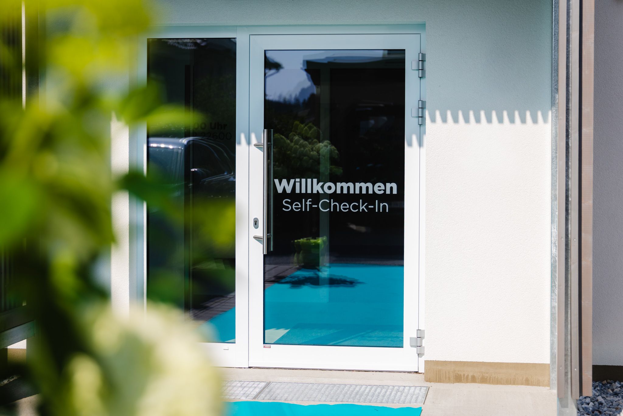 A white door with the words "Welcome to Self-Check-In" on it.