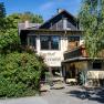 Gasthof Scherrerwirt with terrace and green surroundings.
