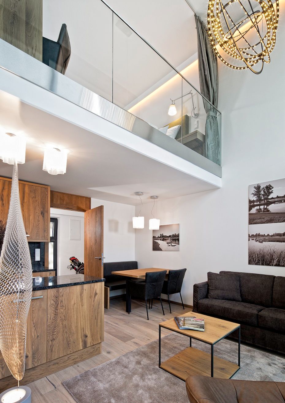 Modern apartment with gallery, wooden furniture and stylish lighting.